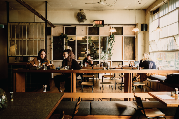 Wide Open Road cafe setting with customers in background.