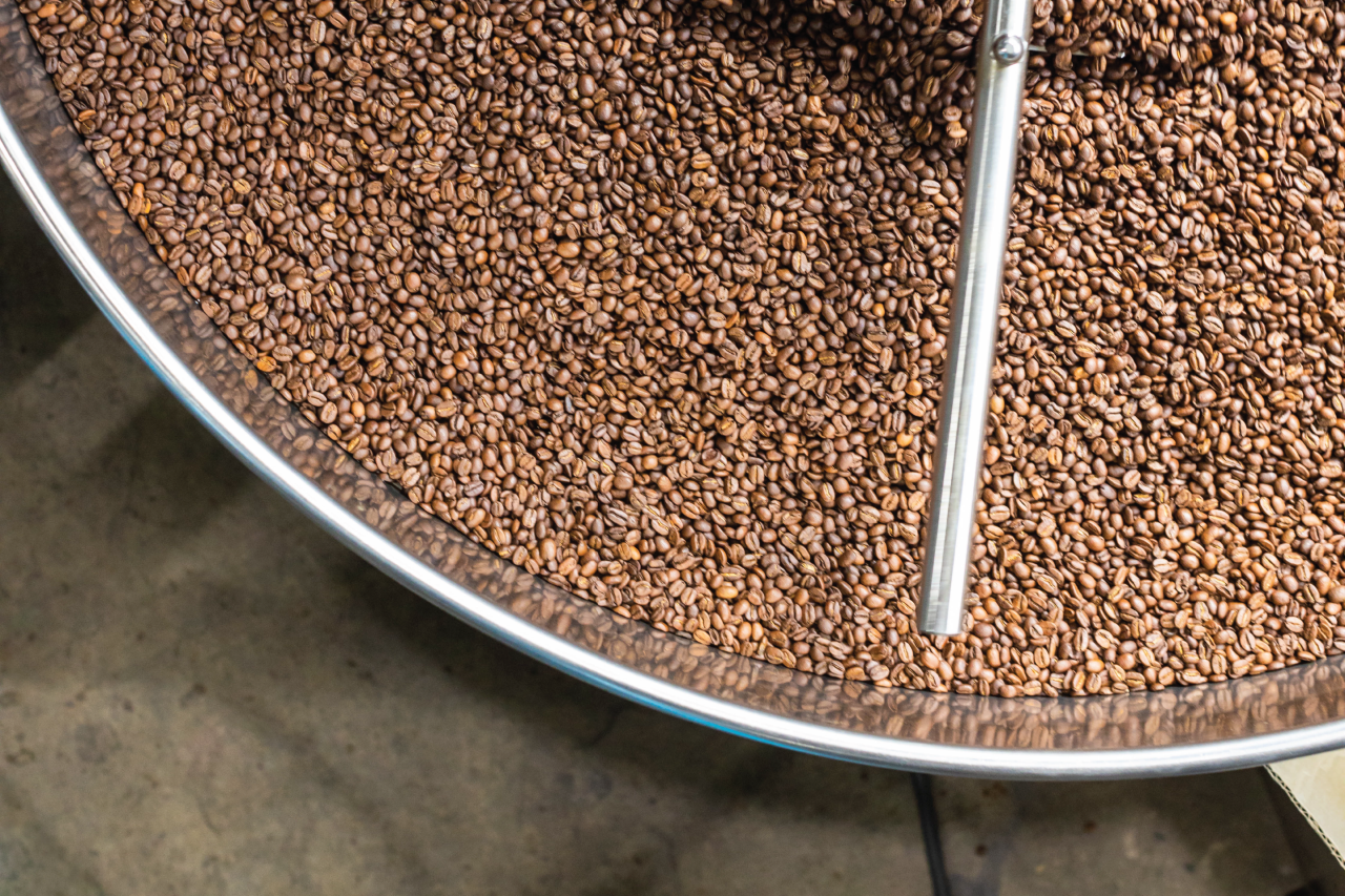Coffee beans in a hopper being roasted.