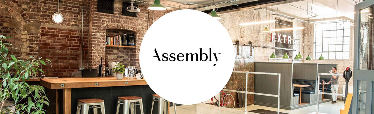 Assembly logo with the roastery in the background.