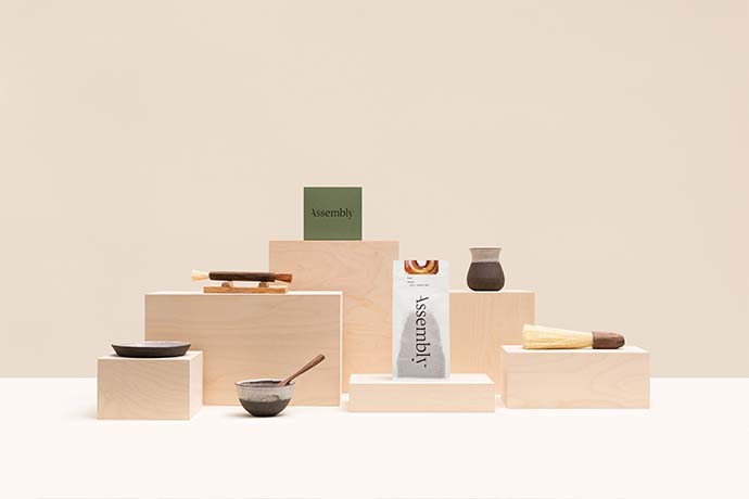 Assembly coffee bag sitting on a wooden base.