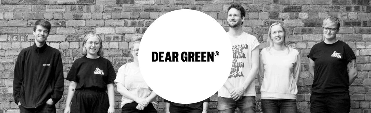 Dear Green logo and coffee roastery staff in the background.