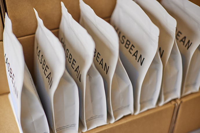 A Hasbean package reads 'Roasted to order, delivered fresh' along with site and social addresses.