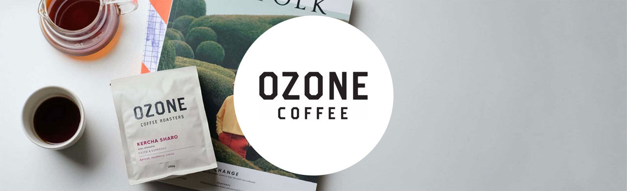 Ozone logo, a coffee cup and Ozone Coffee Roasters Kercha Sharo on top of a magazine.