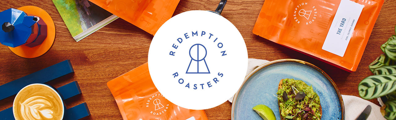 Redemption Roasters logo, a coffee bag and breakfast served on a table. 
