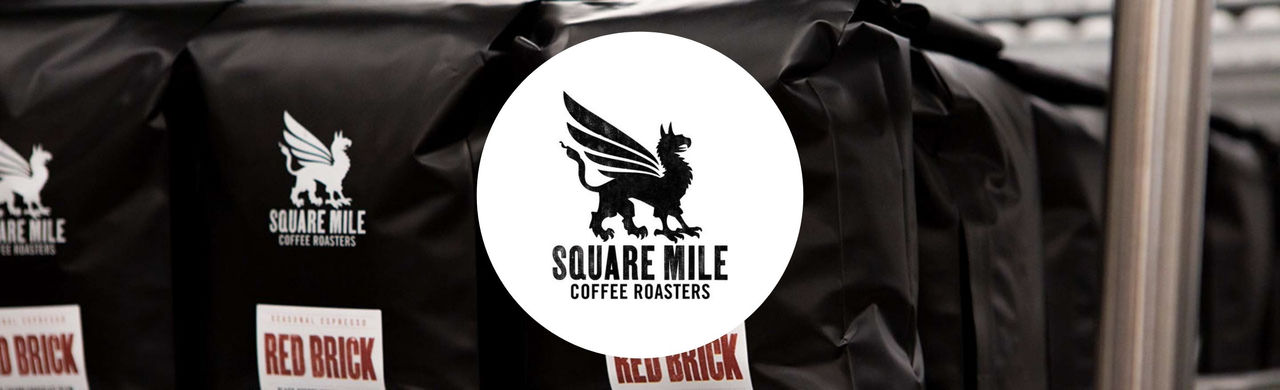 Workshop logo and coffee beans mid-air.