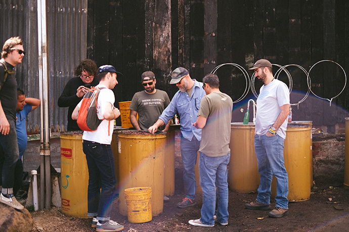 Airship roasters giving a tour to visitors and talking around their drums of beans.
