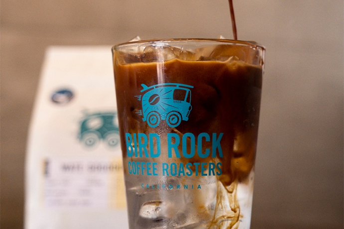 Iced Bird Rock Coffee Roasters coffee in a Bird Rock Coffee Roasters glass.