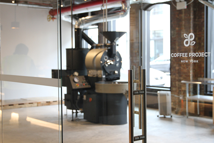 Coffee Project NY roastery glassdoor with a roaster behind those doors.