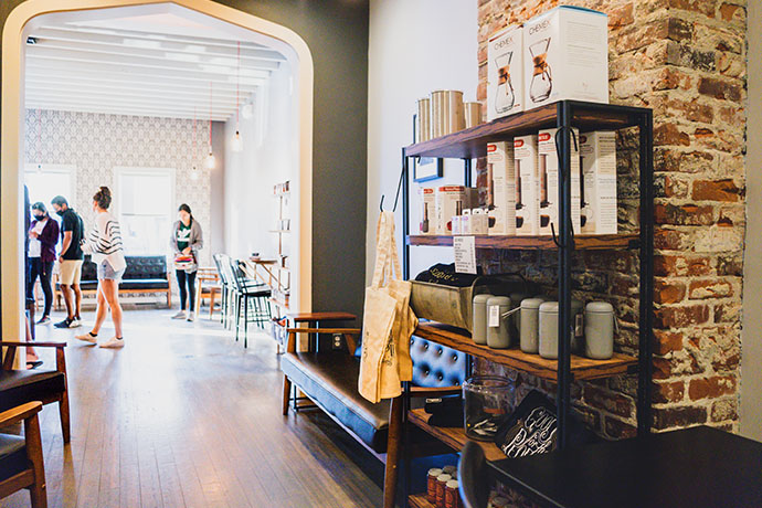 Deeper Roots cafe location with coffee product on shelves.