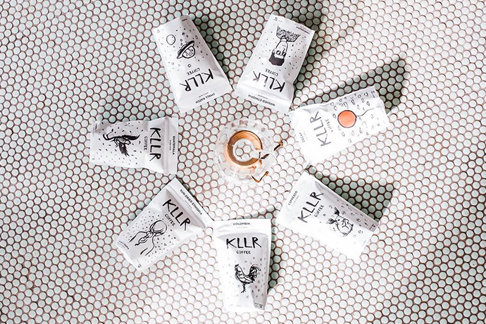 Overhead shot of KLLR coffee beans in bags around a Chemex brewer.