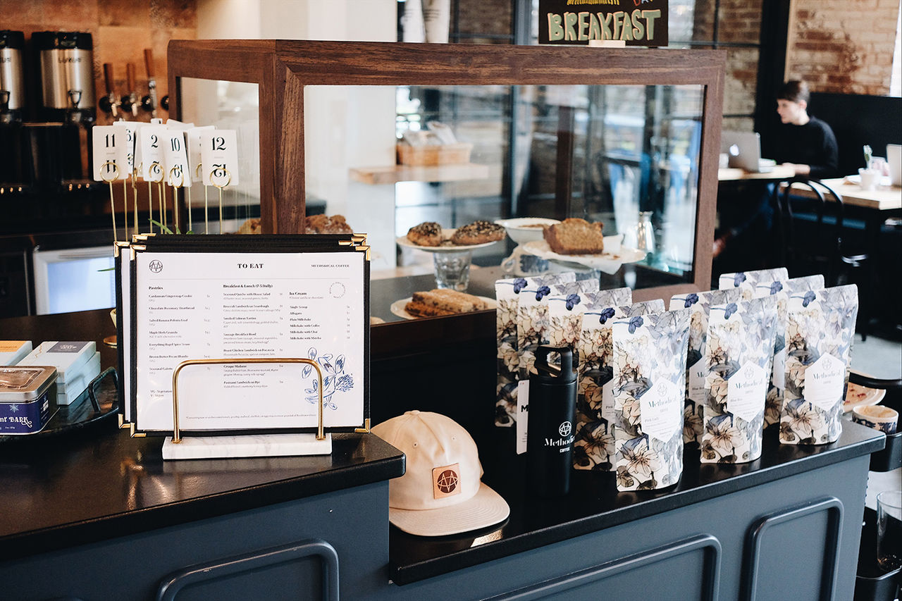 Methodical cafe with menu on display and bags of Methodical coffee beans.