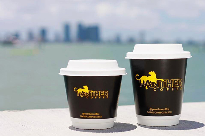 Panther coffee cups with yellow panther motif on display.