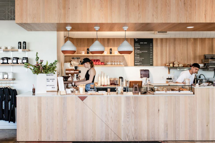 Side profile of Upper Left Roasters cafe location with barista working.