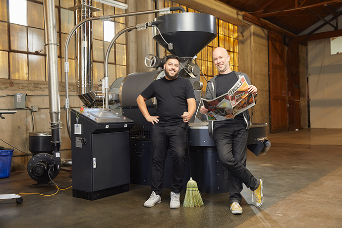 Yes Plz founders standing in front of their roasting machine.