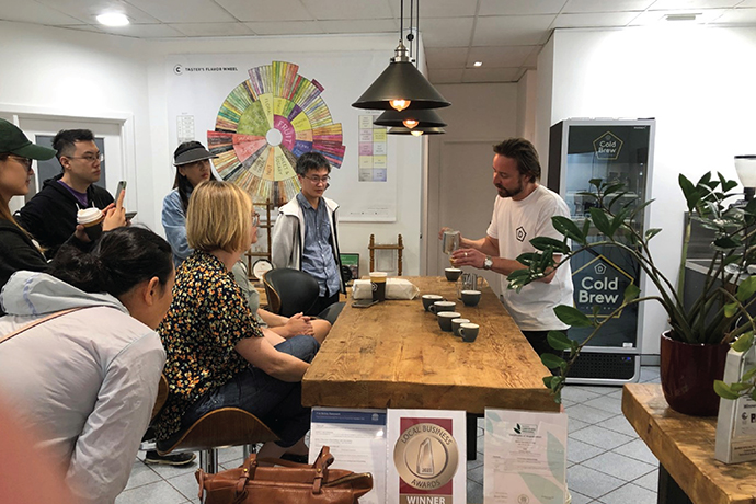 Danes coffee specialist at a cupping session informing audience.